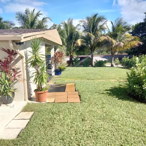 a view of a backyard with swimming pool