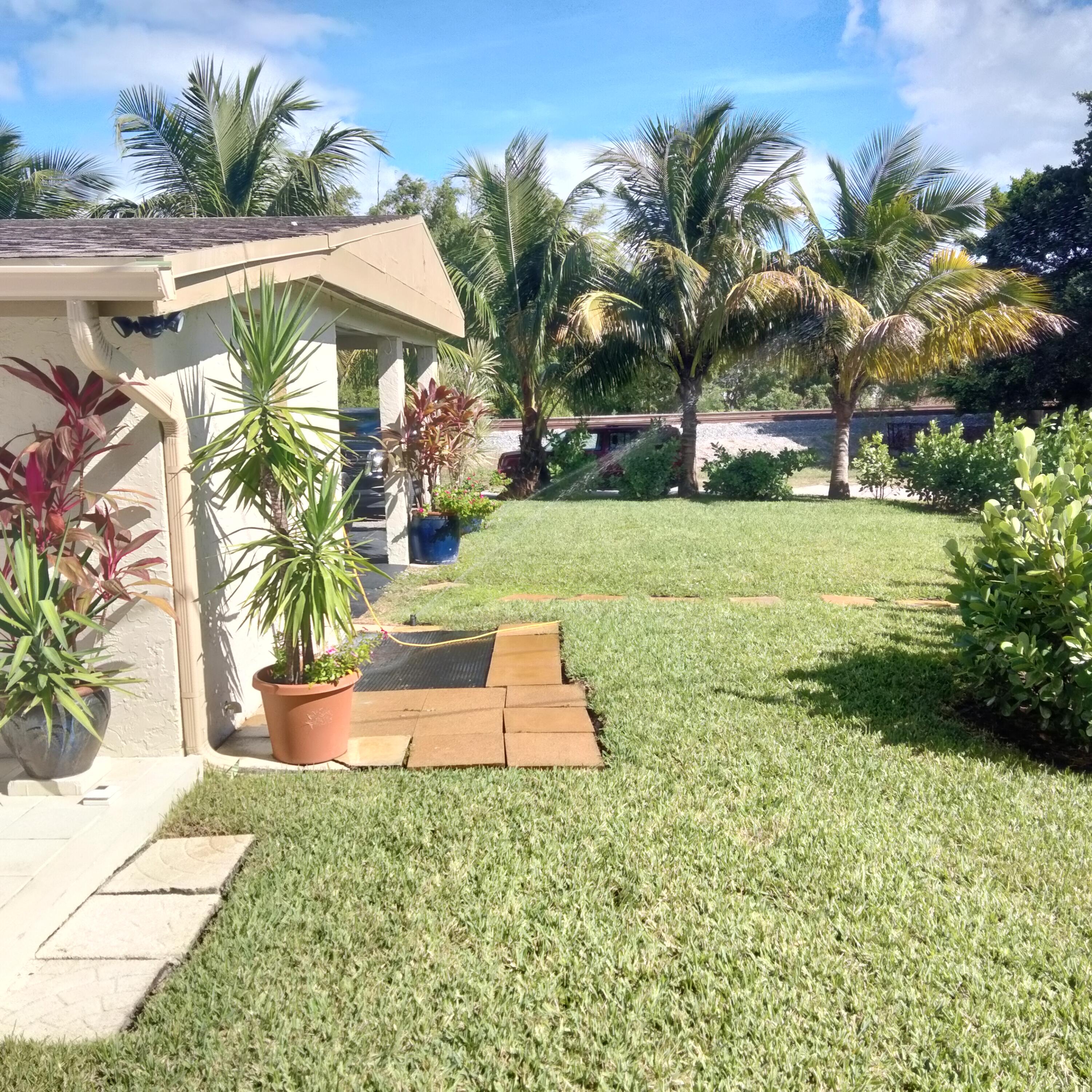 1150 Northeast County Line Road Jensen Beach, FL 34957 - Photo 17 of 17 a view of a backyard with swimming pool