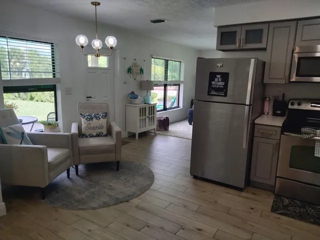 a living room with furniture and a chandelier