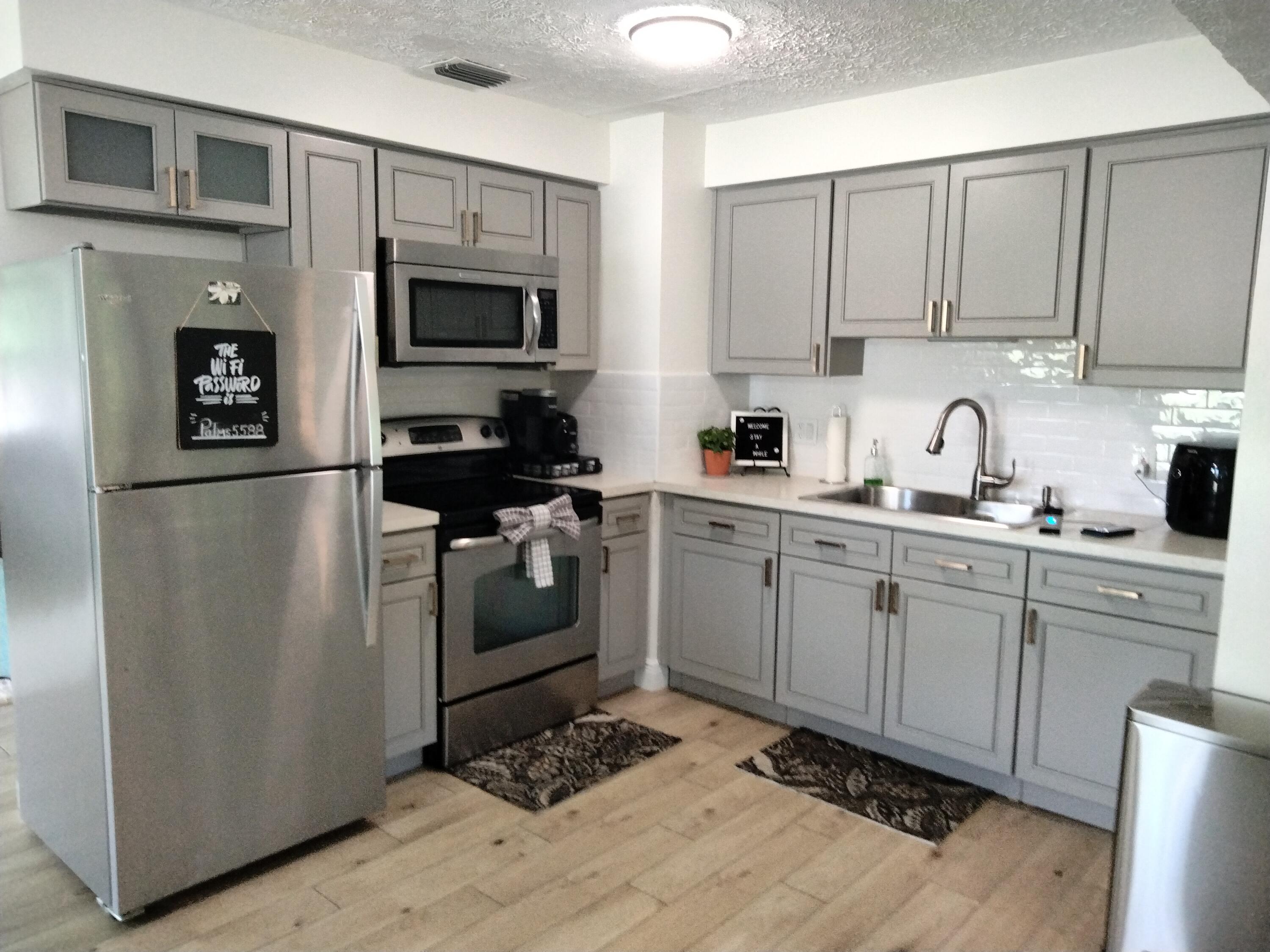 1150 Northeast County Line Road Jensen Beach, FL 34957 - Photo 6 of 17 a kitchen with cabinets stainless steel appliances and a counter space