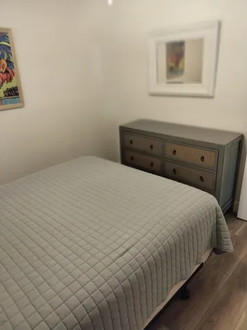a large bed sitting in a bedroom next to a bathroom