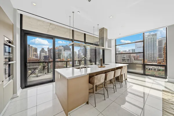 a large kitchen with a table and chairs