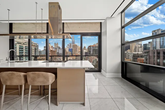 a open kitchen with granite countertop a coffee table and chairs