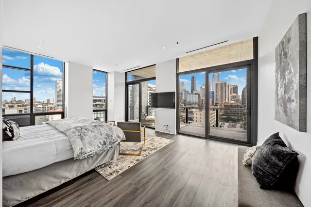 a bedroom with a large bed and a large window