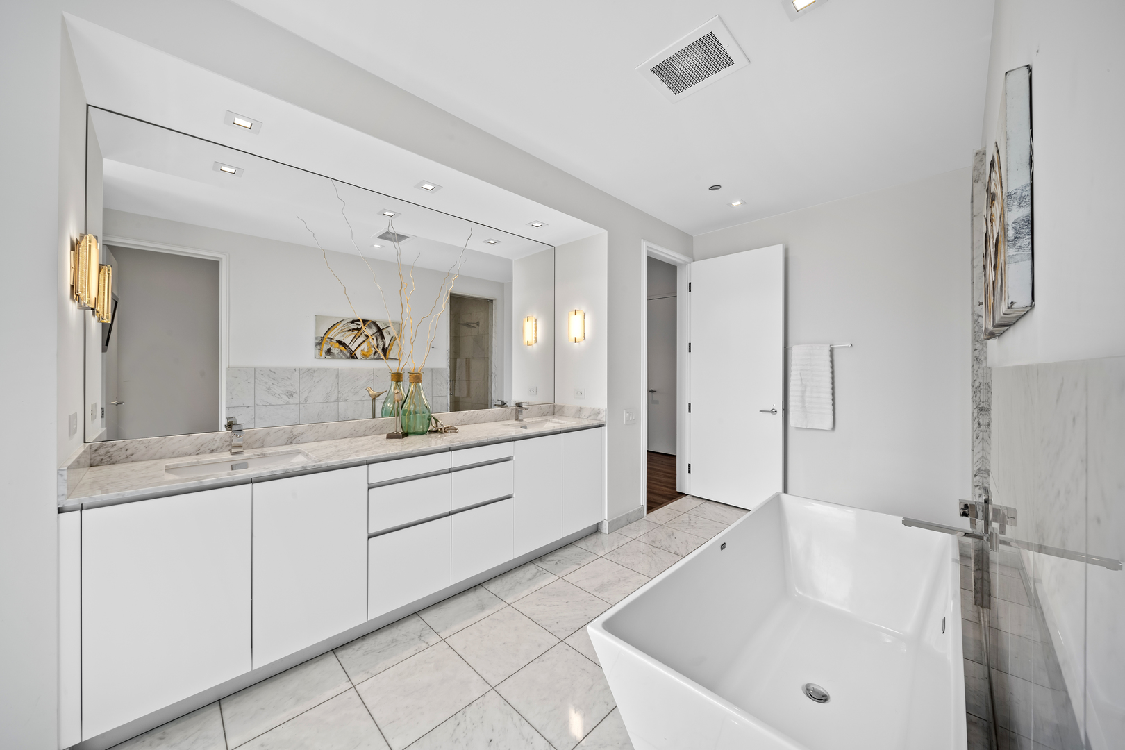 400 West Huron Street, Unit 1001 Chicago, IL 60654 - Photo 23 of 41 a spacious bathroom with a granite countertop sink mirror and bathtub