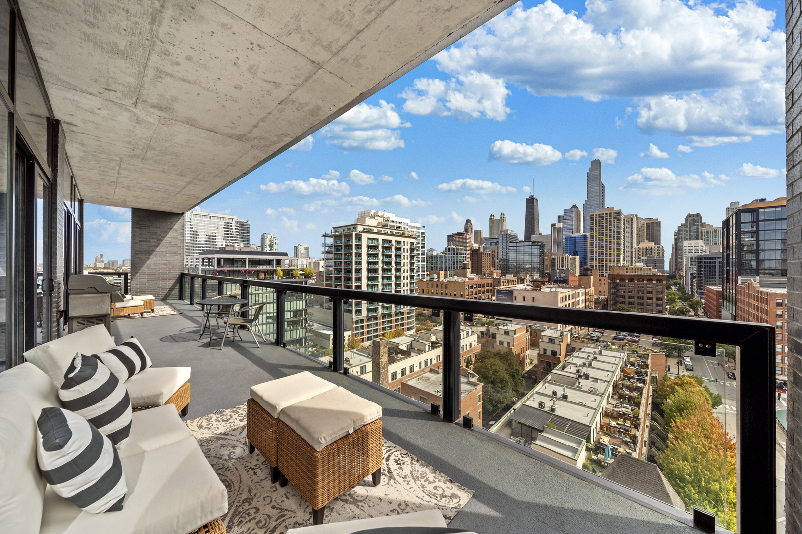 400 West Huron Street, Unit 1001 Chicago, IL 60654 - Photo 33 of 41 a view of a balcony with chairs and wooden floor