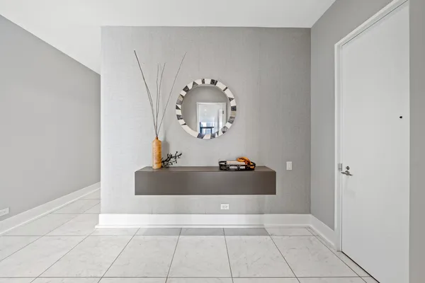 a living room with a mirror and rug