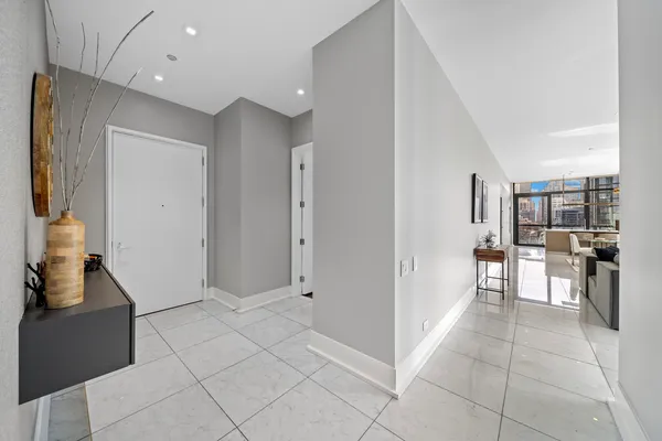 a view of a kitchen with furniture and an empty room