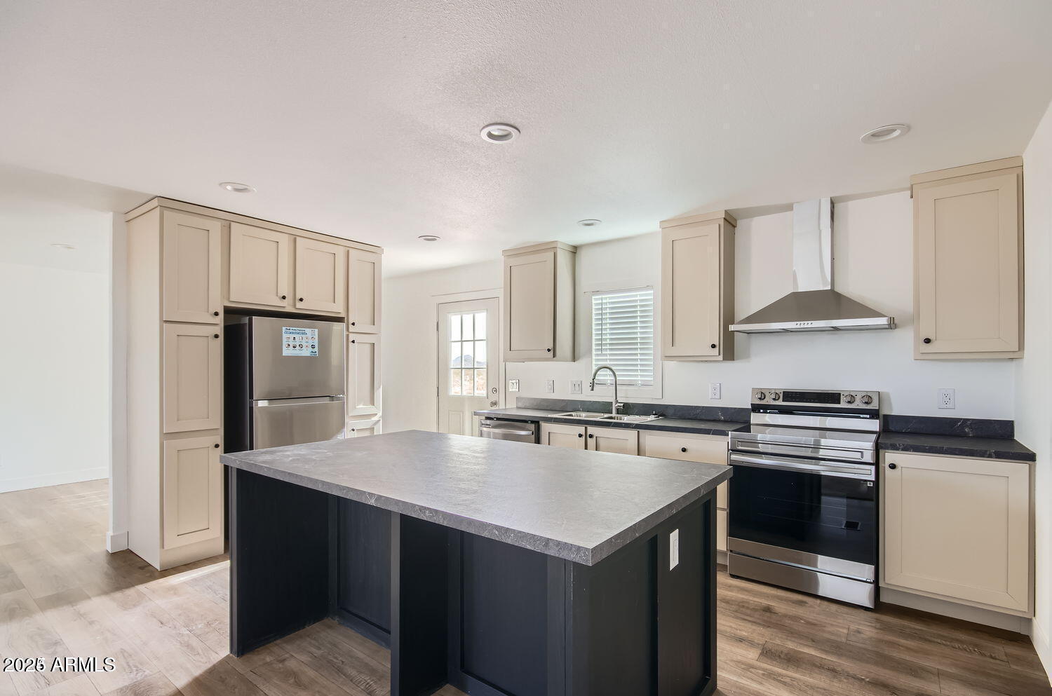 2679 West Manzanita Street Apache Junction, AZ 85120 - Photo 3 of 8 a kitchen with a stove a sink and a refrigerator