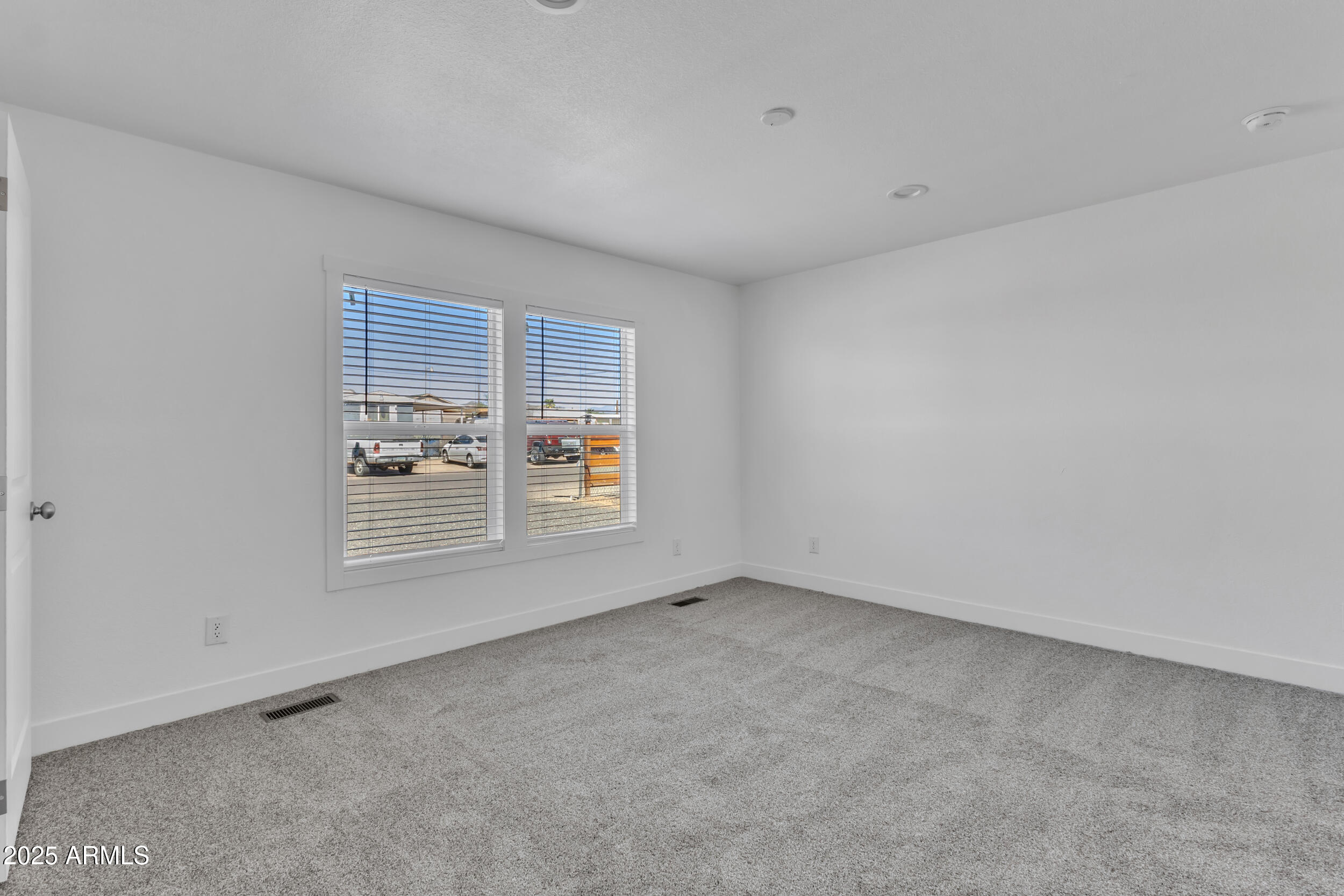 2679 West Manzanita Street Apache Junction, AZ 85120 - Photo 5 of 8 an empty room with a window