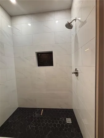 a bathroom with a toilet sink double vanity and mirror
