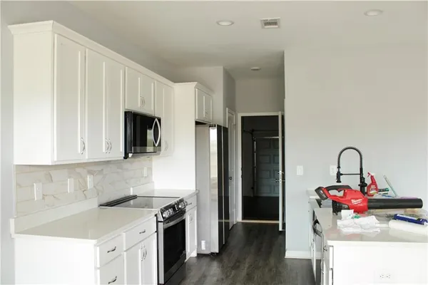 a kitchen with a sink stove and refrigerator