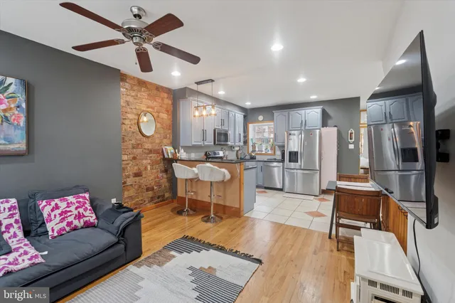 a living room with stainless steel appliances kitchen island granite countertop furniture and a kitchen view