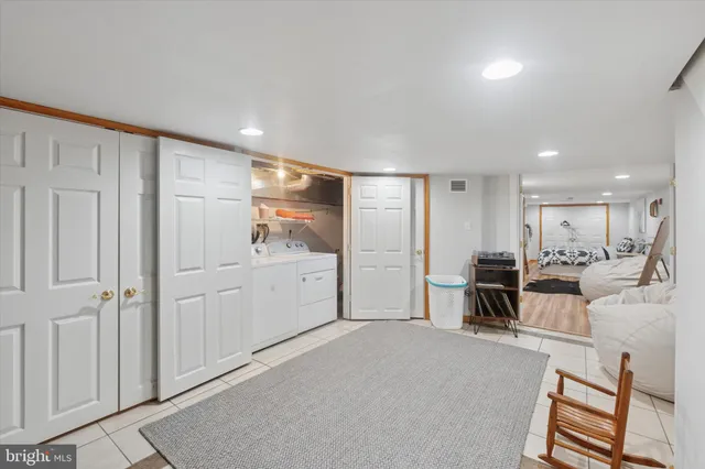 a living room with furniture a flat screen tv and a sink