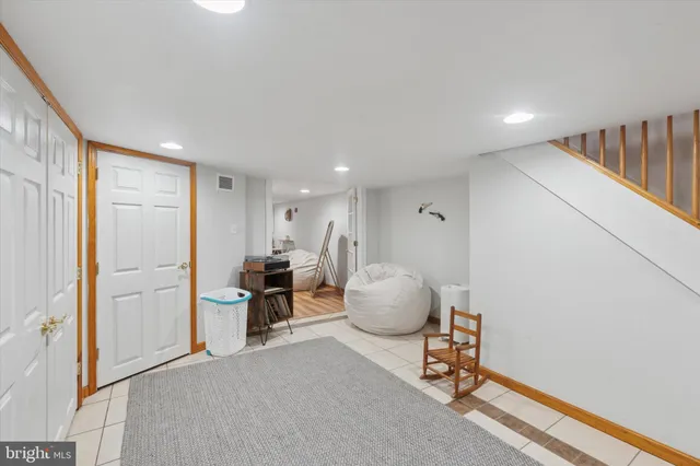 a hallway with wooden floor and furniture
