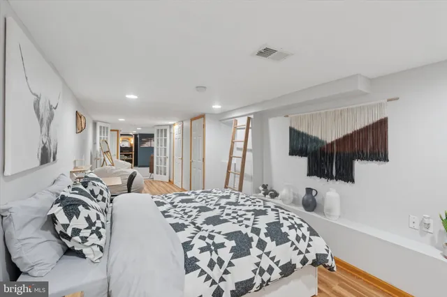 a bedroom with a bed a couch and a window