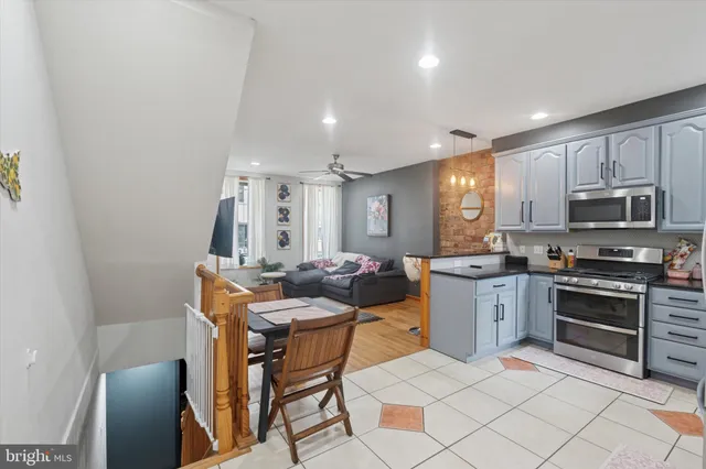 a kitchen with granite countertop a sink cabinets and stainless steel appliances