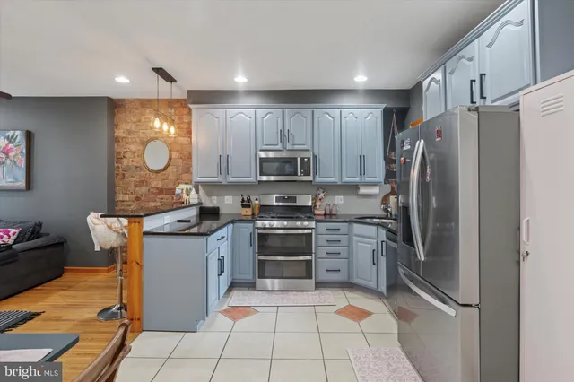 a kitchen with stainless steel appliances granite countertop a refrigerator oven a sink and dishwasher