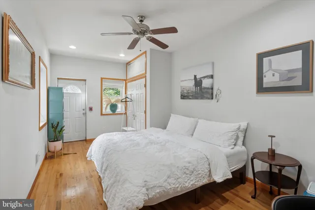 a spacious bedroom with a bed and a chandelier