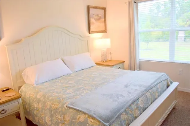 a bedroom with a bed and a window