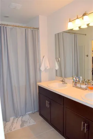 a bathroom with a double vanity sink and a mirror