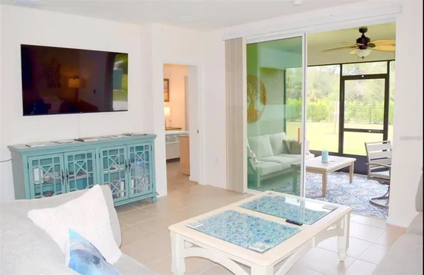 a living room with furniture and a floor to ceiling window