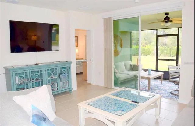a living room with furniture and a floor to ceiling window