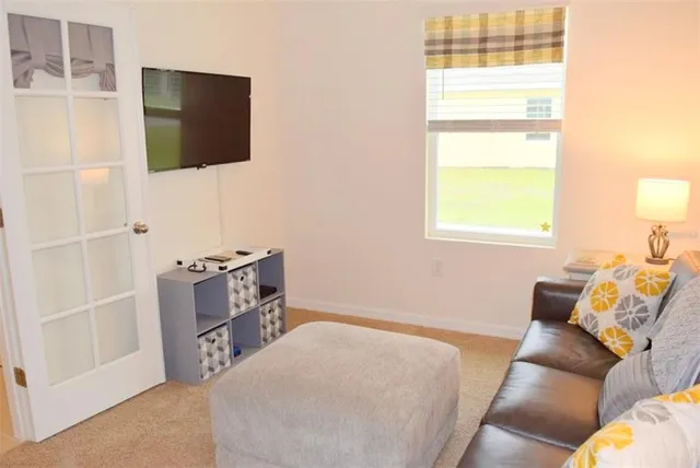 a living room with furniture and a flat screen tv