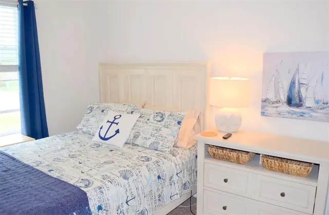 a bedroom with a bed and a window