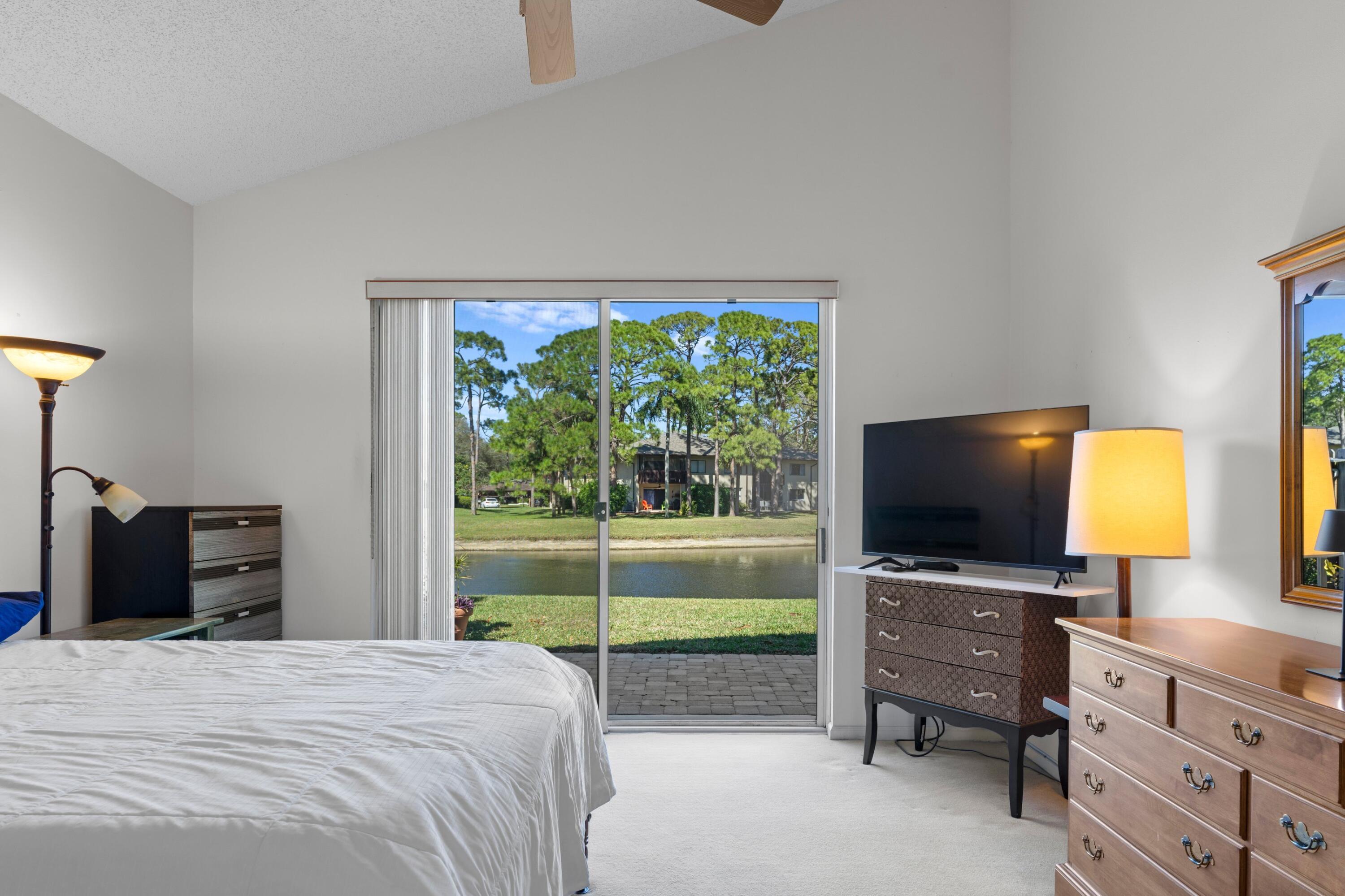 7676 Kings Ride Boynton Beach, FL 33436 - Photo 11 of 41 a bedroom with a bed and television