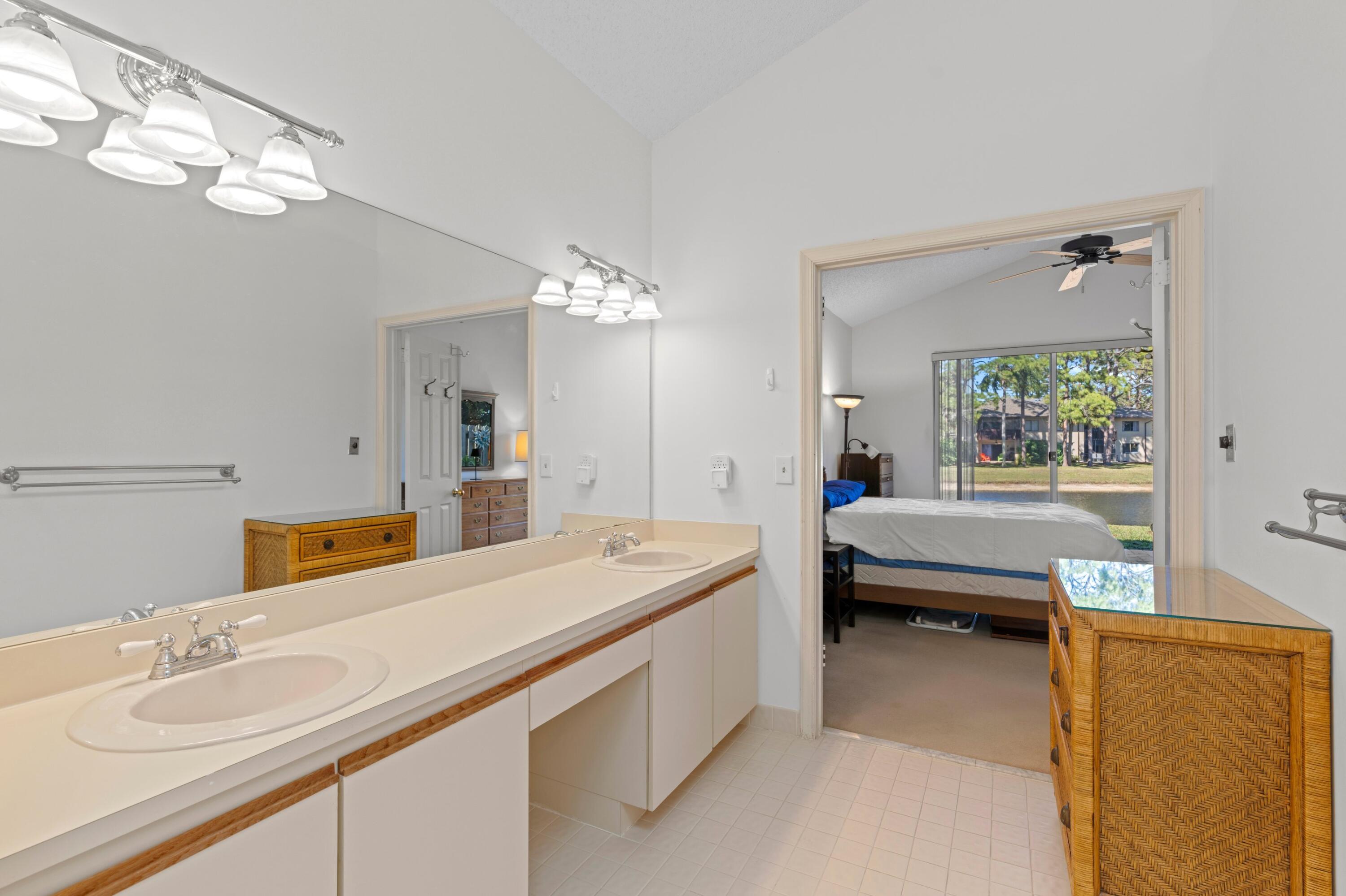 7676 Kings Ride Boynton Beach, FL 33436 - Photo 12 of 41 a spacious bathroom with a tub double sink and mirror