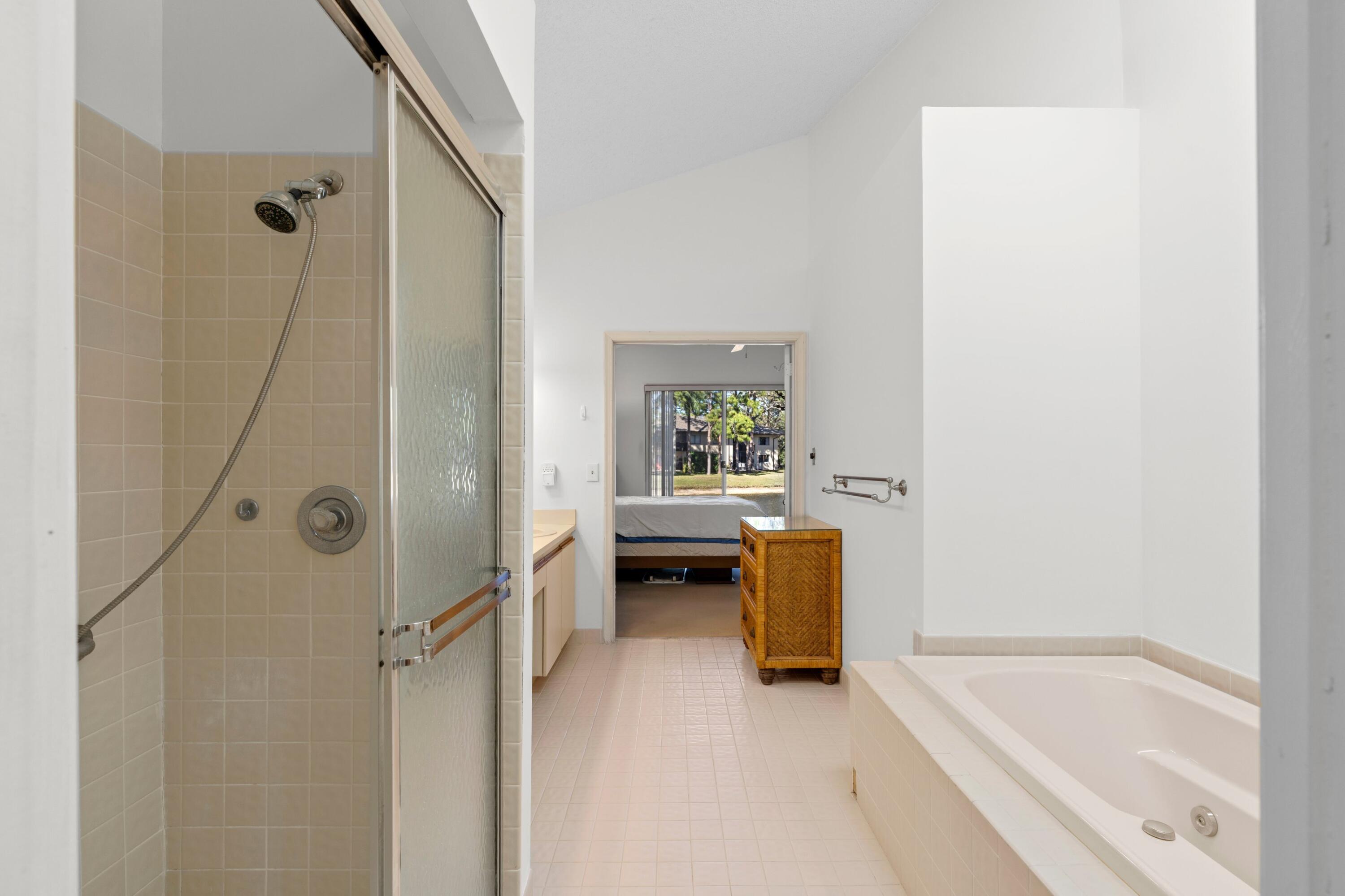 7676 Kings Ride Boynton Beach, FL 33436 - Photo 13 of 41 a bathroom with a tub shower and a sink