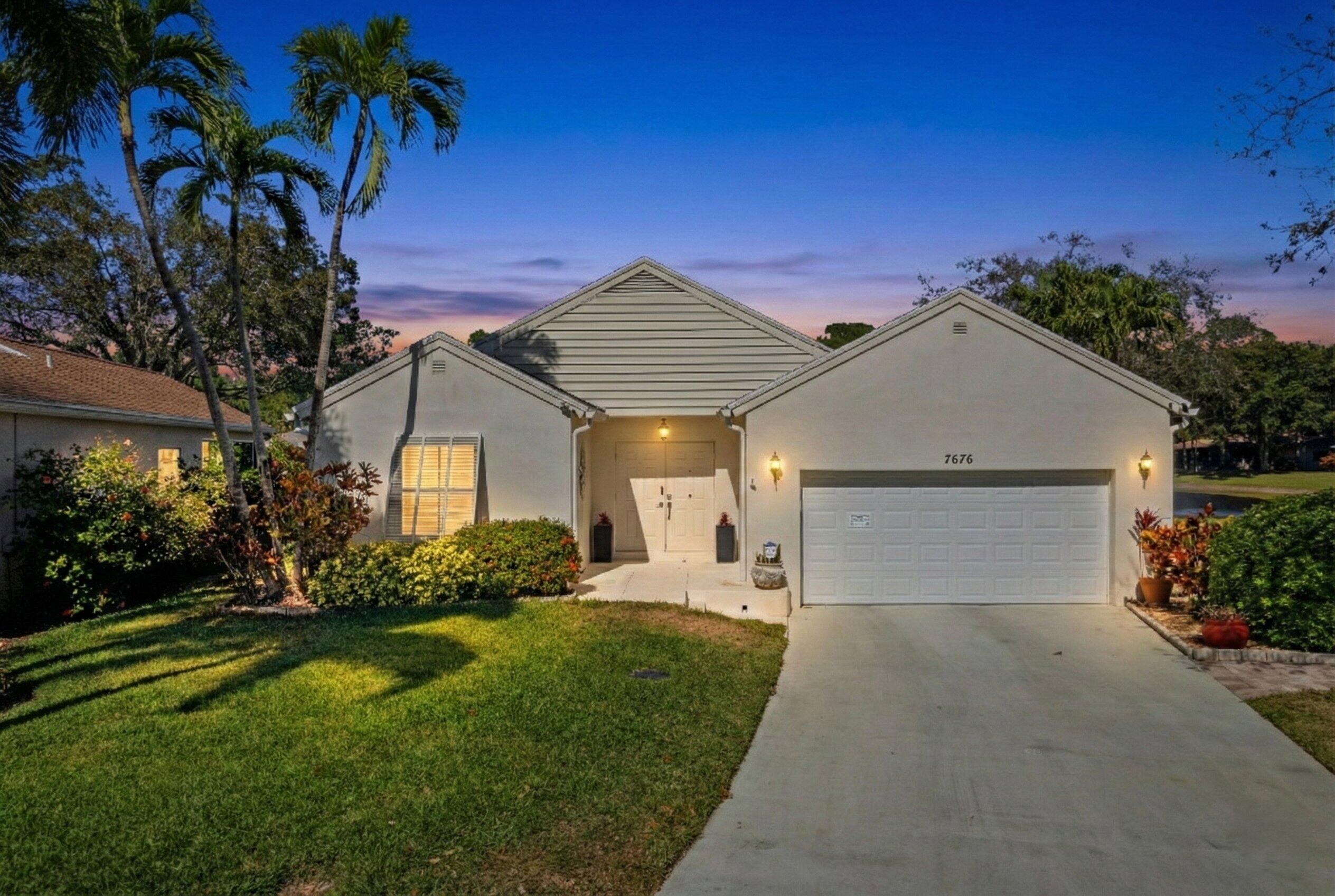 7676 Kings Ride Boynton Beach, FL 33436 - Photo 26 of 41 a front view of a house with a yard and garage