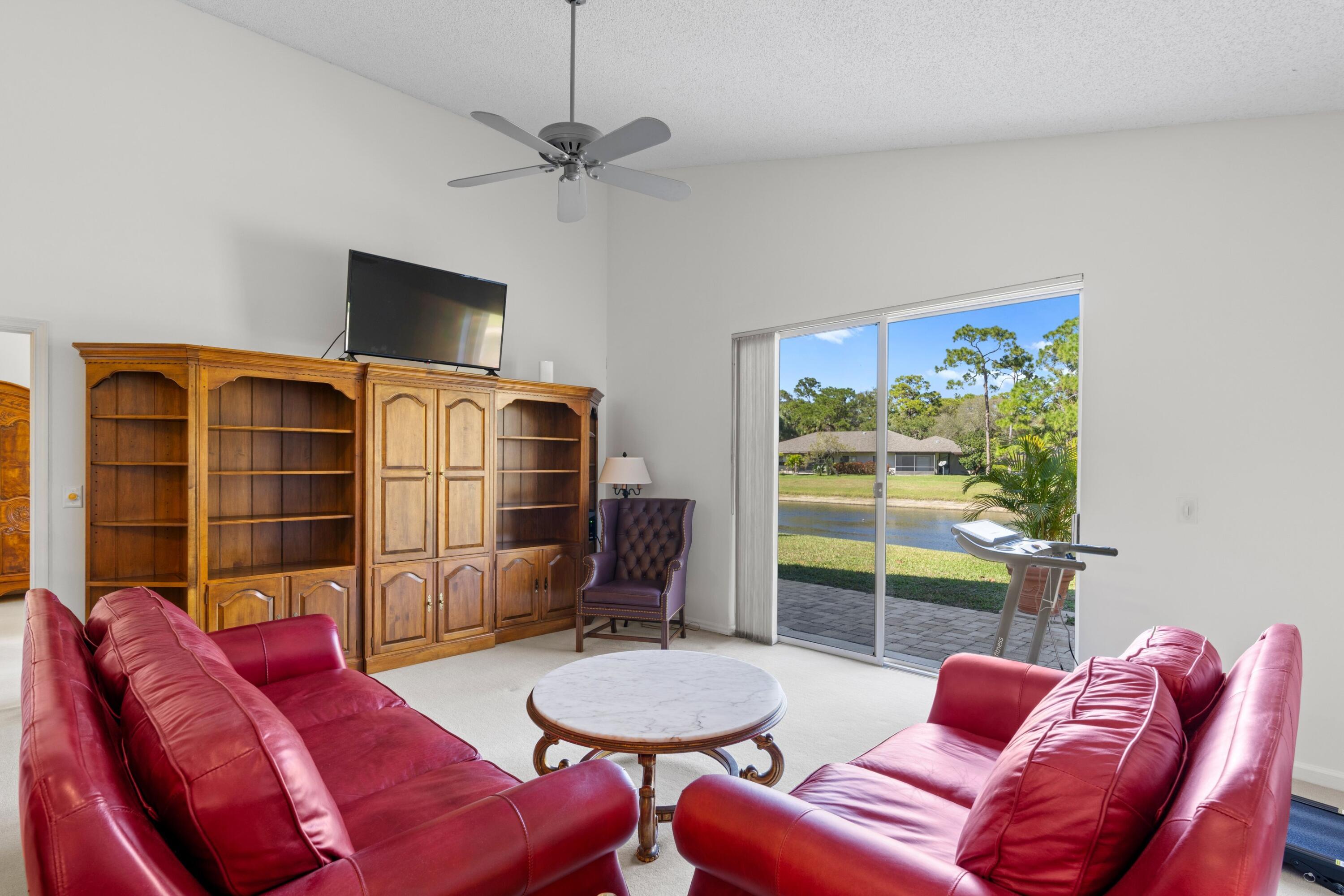 7676 Kings Ride Boynton Beach, FL 33436 - Photo 5 of 41 a living room with furniture a flat screen tv and a window