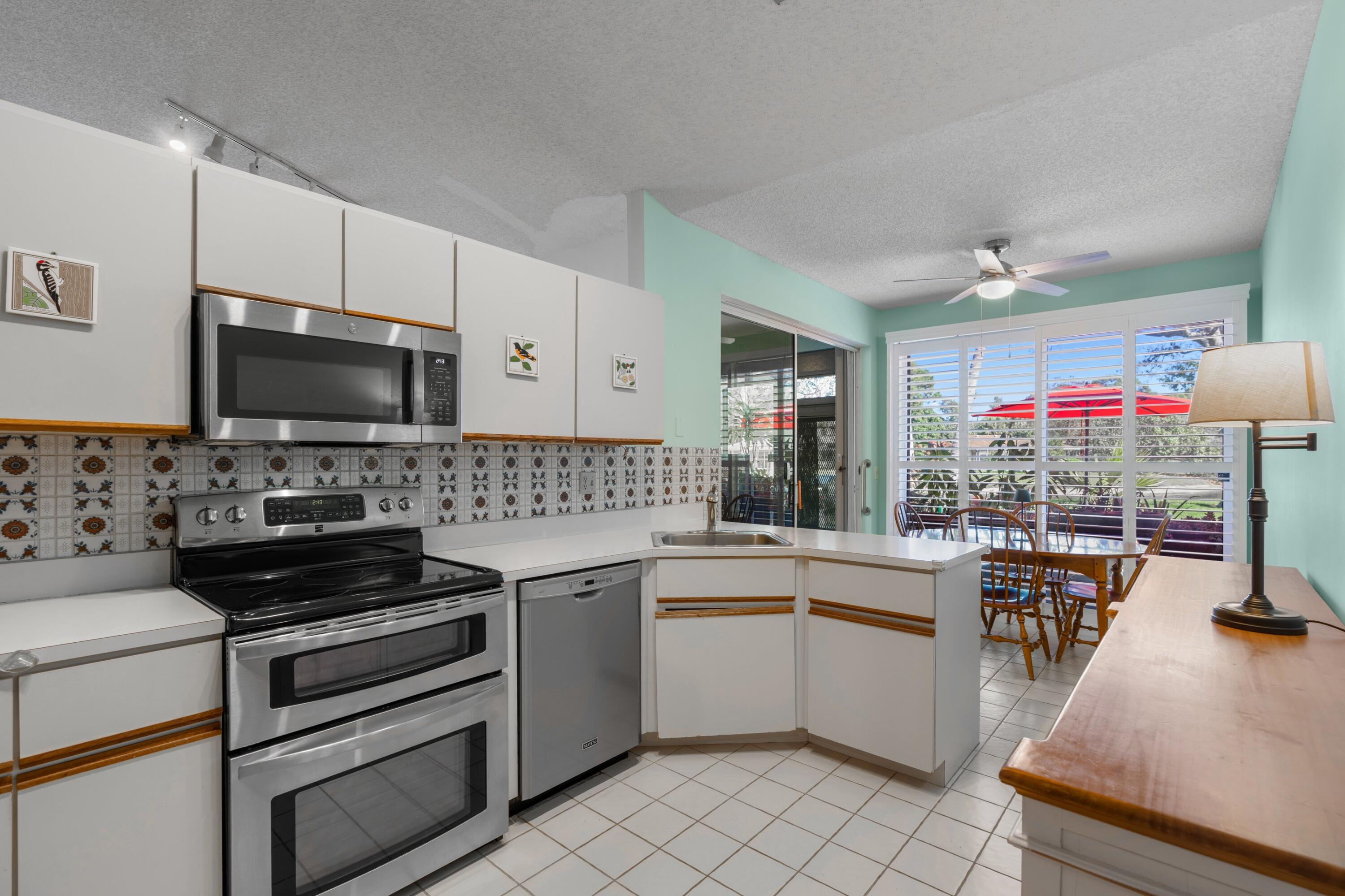 7676 Kings Ride Boynton Beach, FL 33436 - Photo 6 of 41 a kitchen that has a sink and a stove top oven