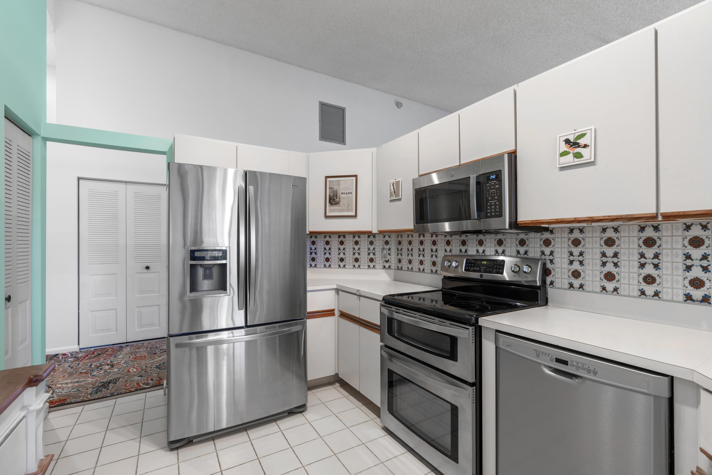 7676 Kings Ride Boynton Beach, FL 33436 - Photo 8 of 41 a kitchen with stainless steel appliances a refrigerator stove and microwave