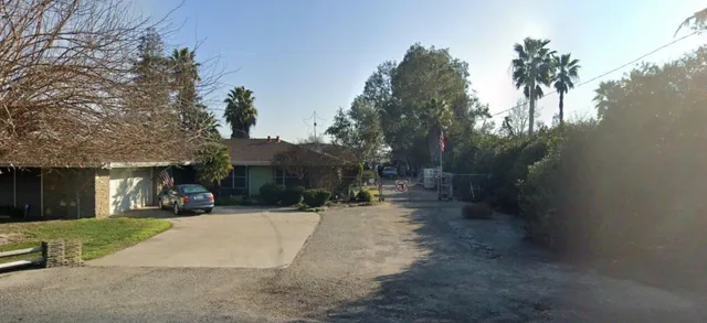 a view of a street with palm trees