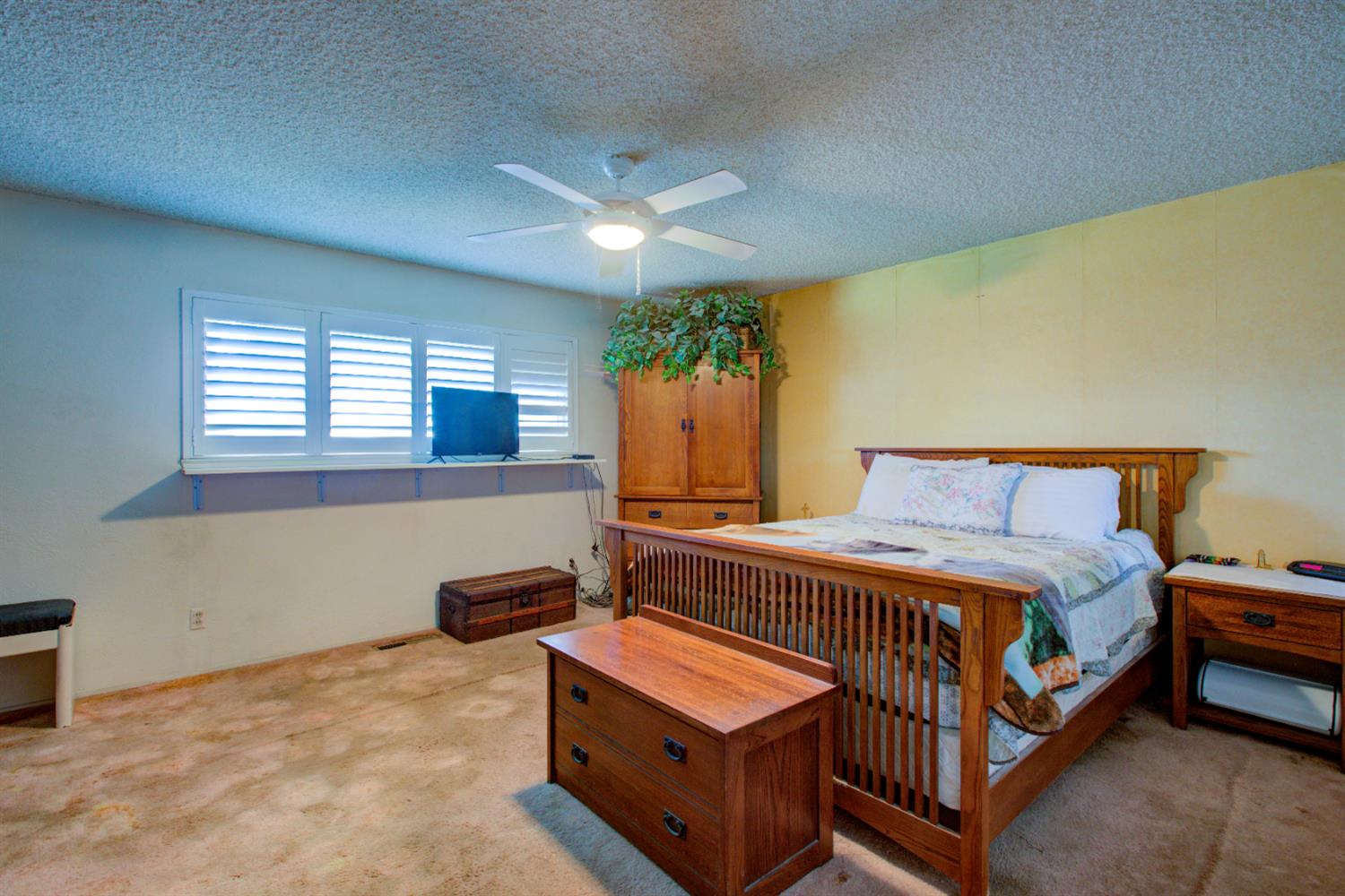 5900 Washington Road Turlock, CA 95382 - Photo 12 of 56 a bedroom with a bed and a lamp with window