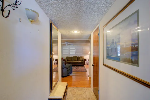 a view of a hallway view with wooden floor and staircase