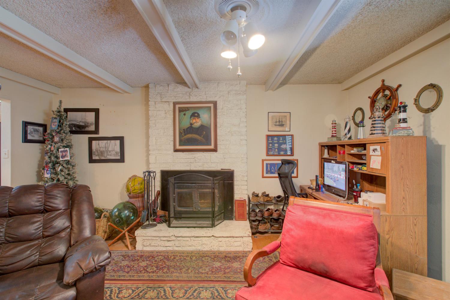 5900 Washington Road Turlock, CA 95382 - Photo 17 of 56 a living room with furniture and a fireplace