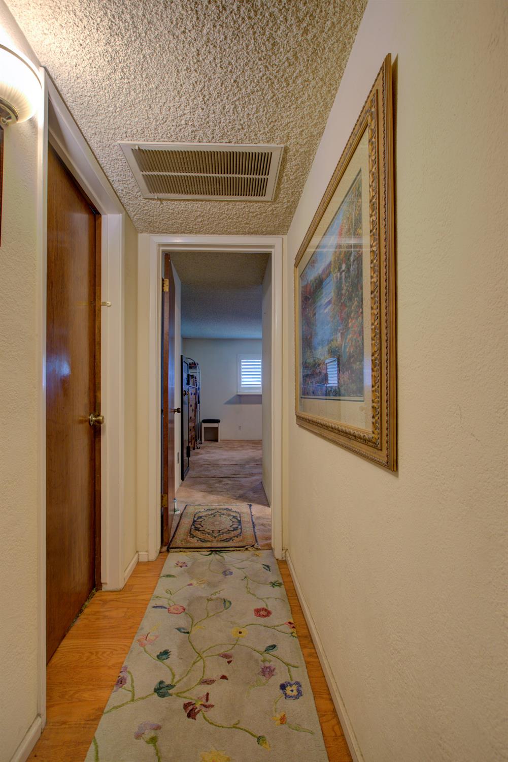 5900 Washington Road Turlock, CA 95382 - Photo 18 of 56 a view of a hallway view with wooden floor and staircase
