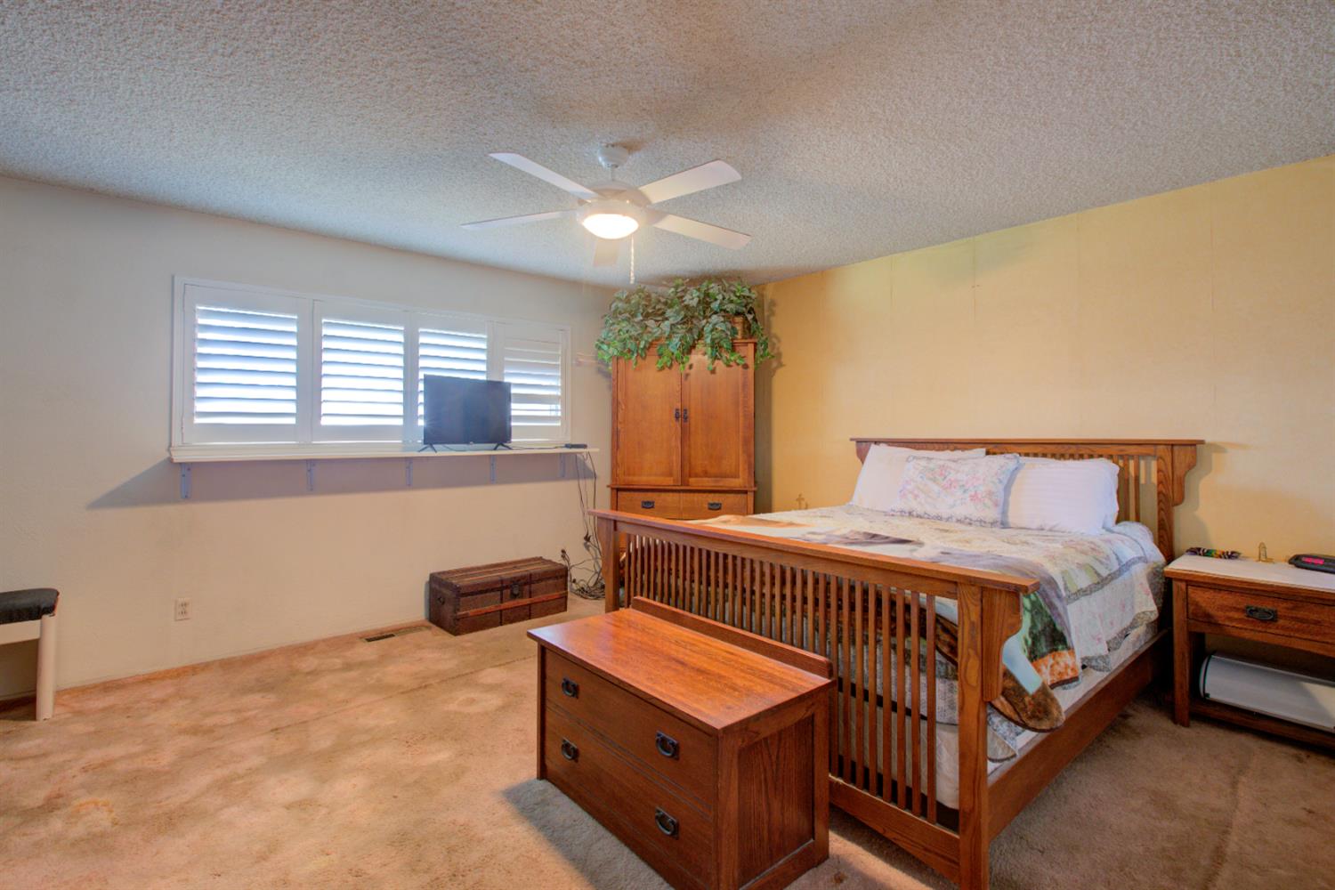 5900 Washington Road Turlock, CA 95382 - Photo 22 of 56 a bedroom with a bed and a dresser next to a window