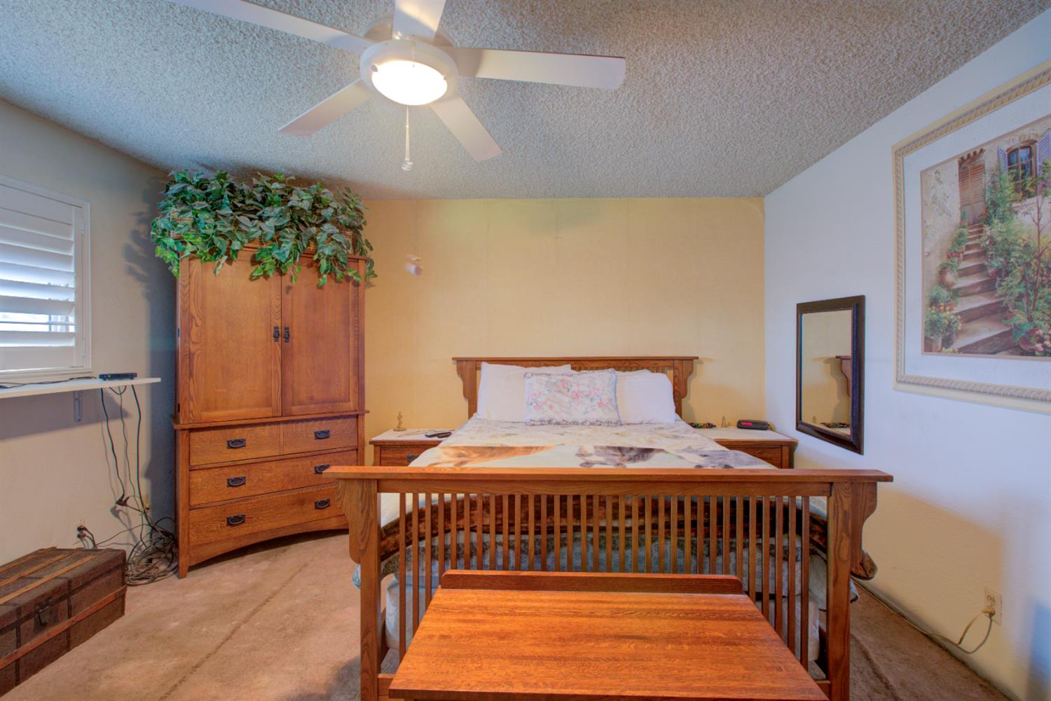 5900 Washington Road Turlock, CA 95382 - Photo 28 of 56 a bedroom with a bed and a chandelier