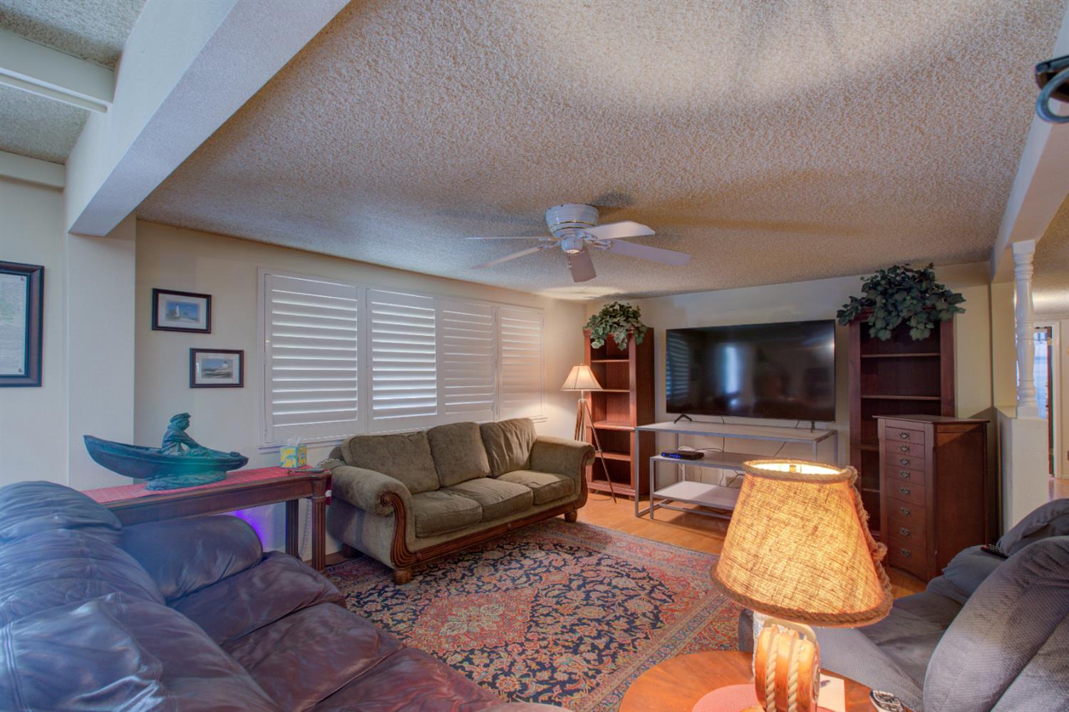 5900 Washington Road Turlock, CA 95382 - Photo 31 of 56 a living room with furniture and a flat screen tv