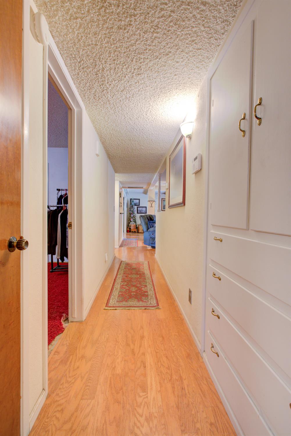 5900 Washington Road Turlock, CA 95382 - Photo 44 of 56 a view of a hallway with wooden floor and staircase