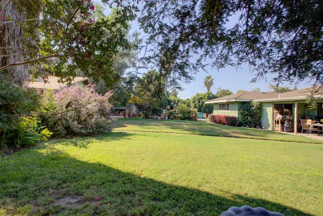 a front view of house with yard and trees