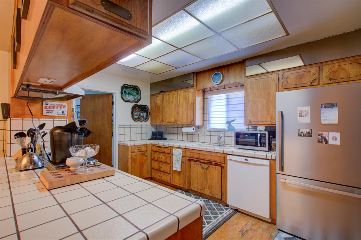 5900 Washington Road Turlock, CA 95382 - Photo 52 of 56 a kitchen with a sink a refrigerator and cabinets