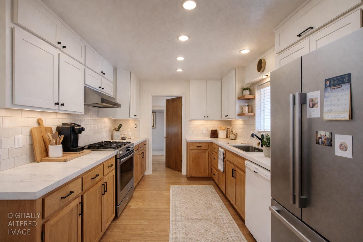 5900 Washington Road Turlock, CA 95382 - Photo 56 of 63 a kitchen with stainless steel appliances granite countertop a stove a sink dishwasher a refrigerator and white cabinets with wooden floor