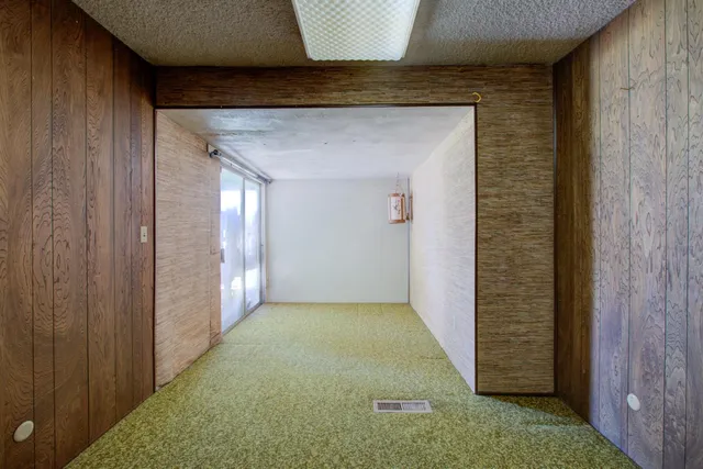 a bedroom with a bed and a lamp with window