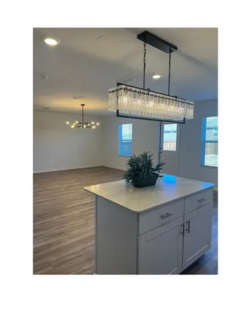 a kitchen with stainless steel appliances granite countertop a sink and a microwave